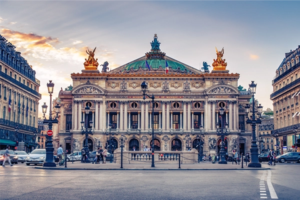 French Opera in Paris, France. Scenic skyline against sunset sky. Travel background.